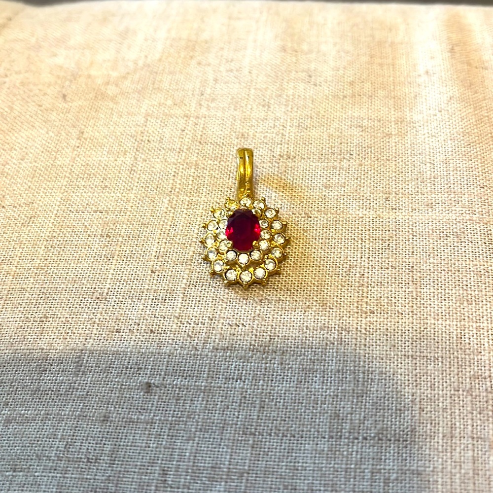 This lovey amethyst and rhinestone or crystal pendant is signed ROMAN.